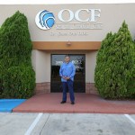 Dr. Carlos Cruz in front of office